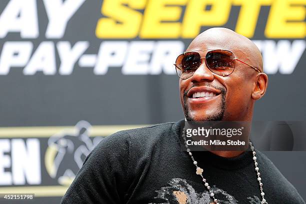 Floyd Mayweather Jr. Ilooks on during a news conference at the Pedestrian Walk in Times Square on July 14, 2014 in New York City. Floyd Mayweather...