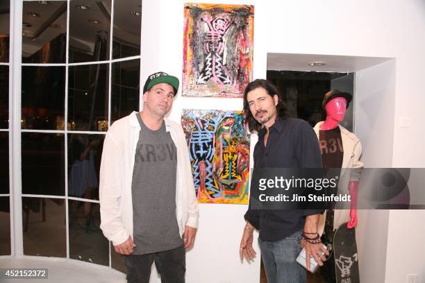 Artist Danny Minnick at his art exhibit poses with Billy Wirth at Gallerie Sparta in Los Angeles, California on July 10, 2014.
