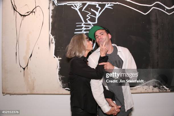 Artist Danny Minnick at his art exhibit poses with Marylin Hassett at Gallerie Sparta in Los Angeles, California on July 10, 2014.