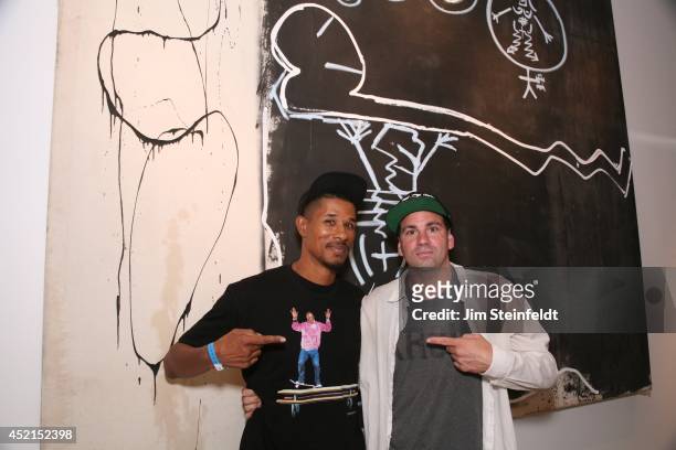 Artist Danny Minnick at his art exhibit poses with Alfonzo Rawls at Gallerie Sparta in Los Angeles, California on July 10, 2014.