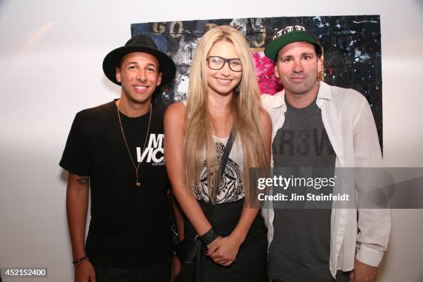 Artist Danny Minnick at his art exhibit poses with Riley Robbins, and Brianne Cordaro at Gallerie Sparta in Los Angeles, California on July 10, 2014.