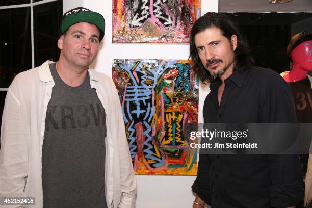 Artist Danny Minnick at his art exhibit poses with Billy Wirth at Gallerie Sparta in Los Angeles, California on July 10, 2014.