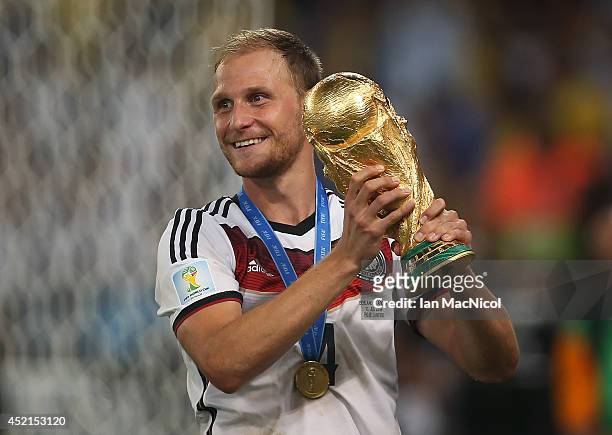 Benedikt Howedes of Germany lifts the trophy during the 2014 World Cup final match between Germany and Argentina at The Maracana Stadium on July 13,...