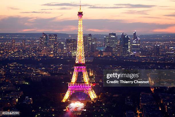 The Eiffel Tower is shown lit up prior a fireworks show to celebrate Bastille Day on July 14, 2014 in Paris, France. Bastille Day commemorates the...