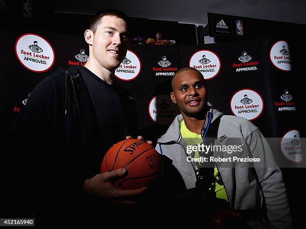 Basketball player Aron Baynes and Australian and San Antonio Spurs NBA basketball player Patty Mills pose for photos during a Footlocker in store...