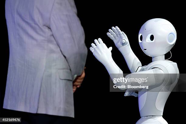 Humanoid robot Pepper, developed by SoftBank Corp.'s Aldebaran Robotics unit, performs next to Masayoshi Son, chairman and chief executive officer of...