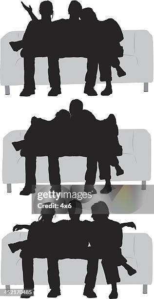 silhouette of friends sitting on a couch - man arm around woman on couch silhouette stock illustrations