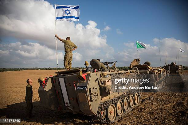 An Israeli soldier stands on top of an armored personnel carrier near the Israeli-Gaza border on July 15, 2014 near Sderot, Israel. As operation...