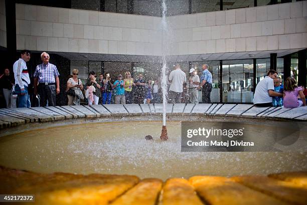 People look at hot spring in the Hot Spring Colonnade on July 12, 2014 in Karlovy Vary, Czech Republic. Karlovy Vary, known for its mineral-rich...