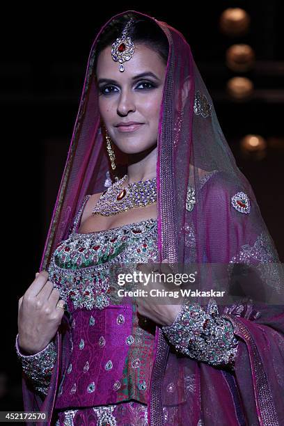 Neha Dhupia walks the runway at Gitanjali Gems show during day 1 of the India International Jewellery Week 2014 at grand Hyatt on July 14, 2014 in...