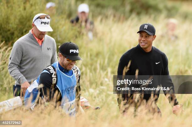 Tiger Woods of the United States walks with Hunter Mahan of the United States and his caddie John Wood during a practice round prior to the start of...