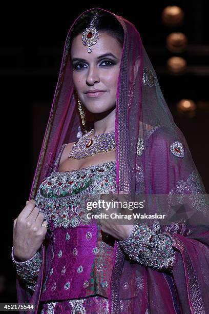 Neha Dhupia walks the runway at Gitanjali Gems show during day 1 of the India International Jewellery Week 2014 at grand Hyatt on July 14, 2014 in...