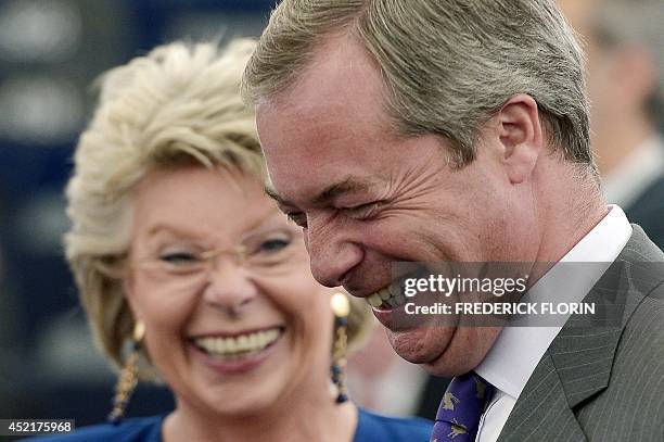 Leader of the UK Independence Party Nigel Farage laughs with European Parliament member Viviane Reding prior to a statement by the centre-right...