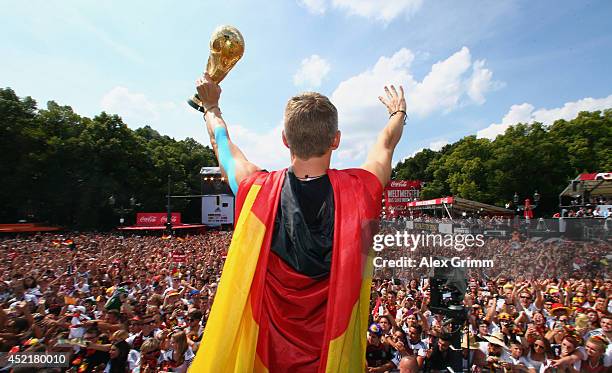 Bastian Schweinsteiger celebrates on stage at the German team victory ceremony on July 15, 2014 in Berlin, Germany. Germany won the 2014 FIFA World...