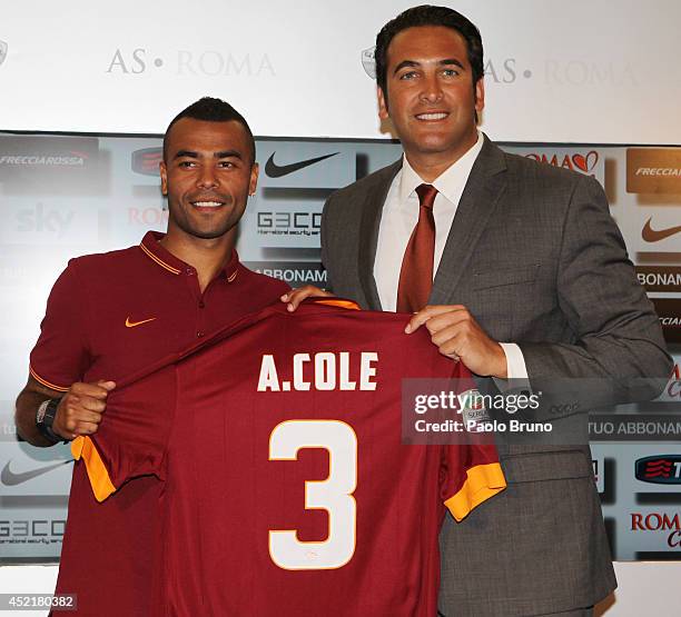 New signing Ashley Cole and AS Roma Ceo Italo Zanzi pose for photographs with AS Roma Shirt during the press conference at the AS Roma Training...