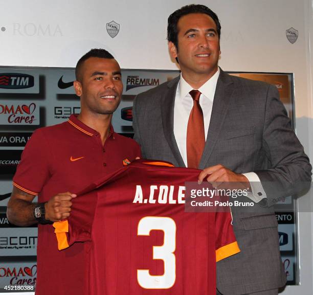 New signing Ashley Cole and AS Roma Ceo Italo Zanzi pose for photographs with AS Roma Shirt during the press conference at the AS Roma Training...