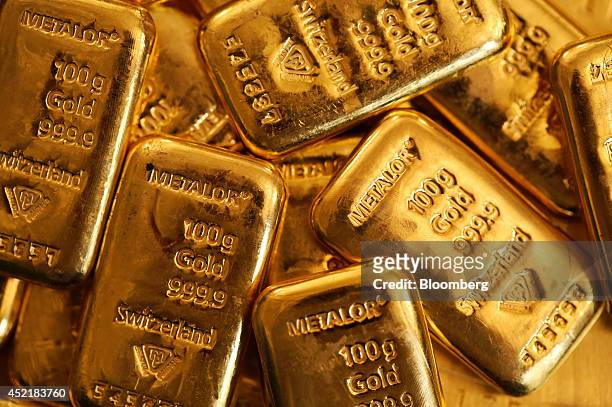 One hundred gram gold bars are seen in this arranged photograph at Gold Investments Ltd. Bullion dealers in London, U.K., on Tuesday, July 15, 2014....