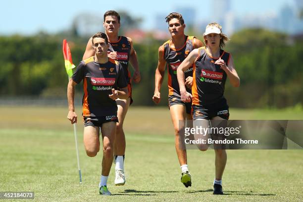 Josh Kelly, Tom Boyd, Rory Lobb and Cameron McCarthy of the Giants run laps poses during a Greater Western Sydney Giants AFL training session at...