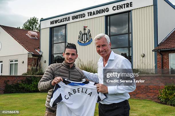 Newcastle United Manager Alan Pardew holds a Newcastle United Shirt with New signing Remy Cabella at The Newcastle United Training Centre on July 13,...