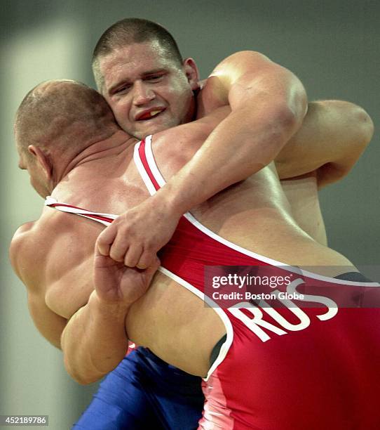 The USA 's Rulon Gardner, in blue, clasps Russia's Alexander Karelin during a 130 kg gold medal match, which Gardner won.