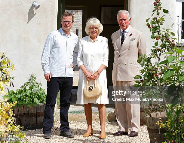 Hugh Fearnley-Whittingstall poses for a photograph with Camilla, Duchess of Cornwall and Prince Charles, Prince of Wales as they tour River Cottage...