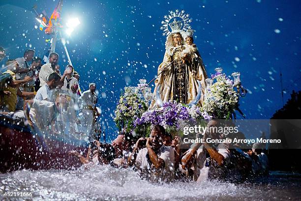 Carriers of the Great God Power brotherhood unload Virgen del Carmen statue after its journey on July 15, 2014 at Puerto de la Cruz dock on the...