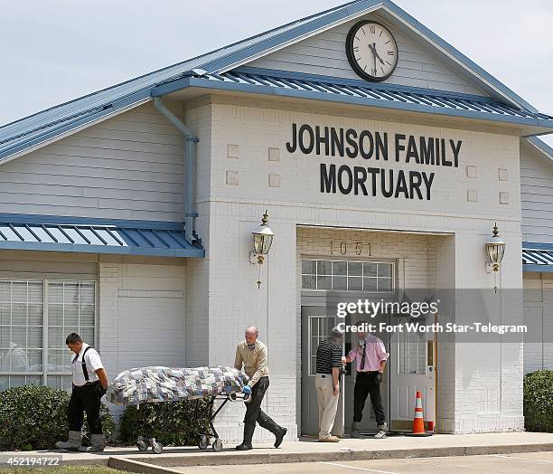 Authorities remove bodies from a Fort Worth, Texas, mortuary on Tuesday, July 15, following a call to police after the business had been vacated....