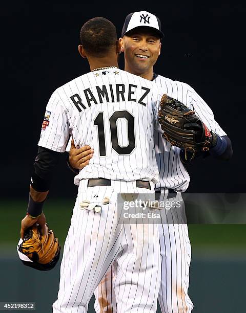 American League All-Star Derek Jeter of the New York Yankees hugs replacement Alexei Ramirez of the Chicago White Sox after being pulled in the...