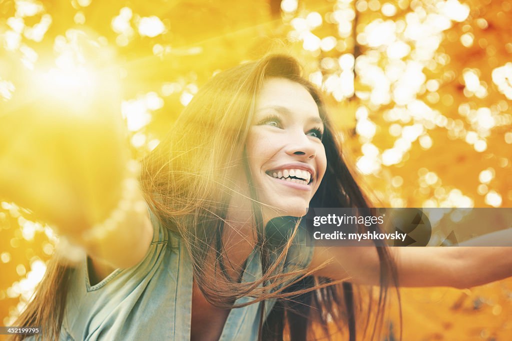 Beautiful woman in Autumn scenery