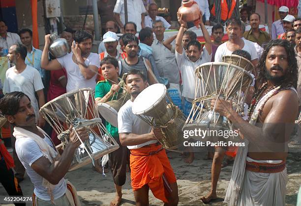 The devotees play the traditional instrument at Kashi Vishwanath Temple during the first Monday of the fifth month in Hindu's calendar Sawan in...