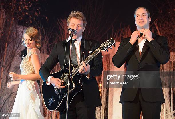 Britain's Prince William, Duke of Cambridge, straightens his bow tie before singing with US musician's Taylor Swift and Jon Bon Jovi at the...