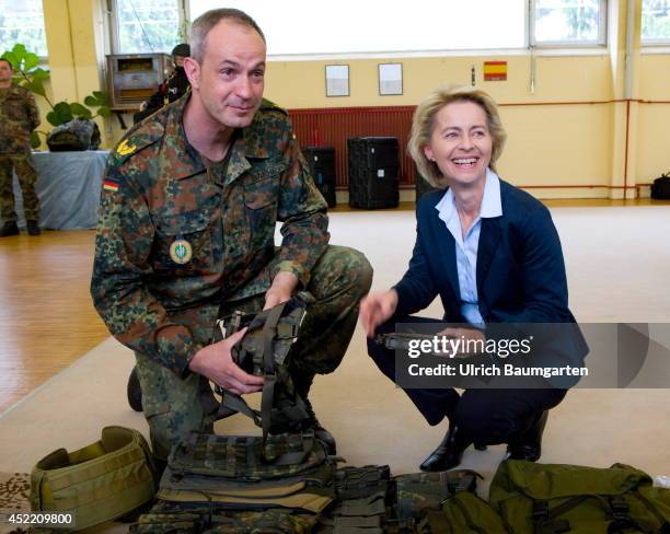 Defence Minister Ursula von der Leyen and Brigade general Dag Baehr, commander of the KSK, examine the equipment of a KSK soldier, on July 14, 2014...