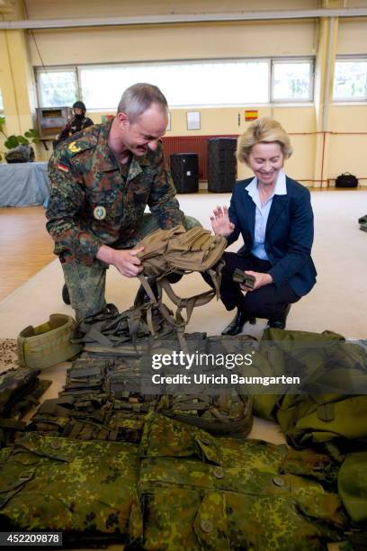 Defence Minister Ursula von der Leyen and Brigade general Dag Baehr, commander of the KSK, examine the equipment of a KSK soldier, on July 14, 2014...