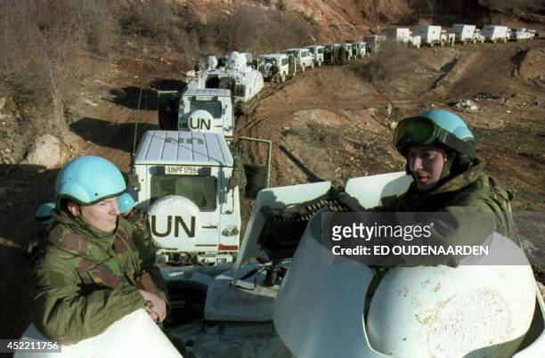 Two Dutch soldiers ride on an armored vehicle accompanying a Dutch UN convoy of 56 engineering vehicles on their way to Lukavac 28 February 1994 in...