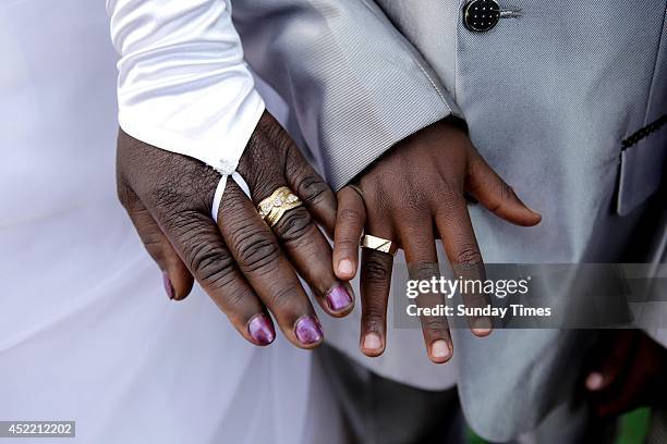 Anele Masilela, a nine year-old watches as his wife Helen Shabangu, 62 year-old kisses her 'real life' husband Abel, at their white wedding on July...