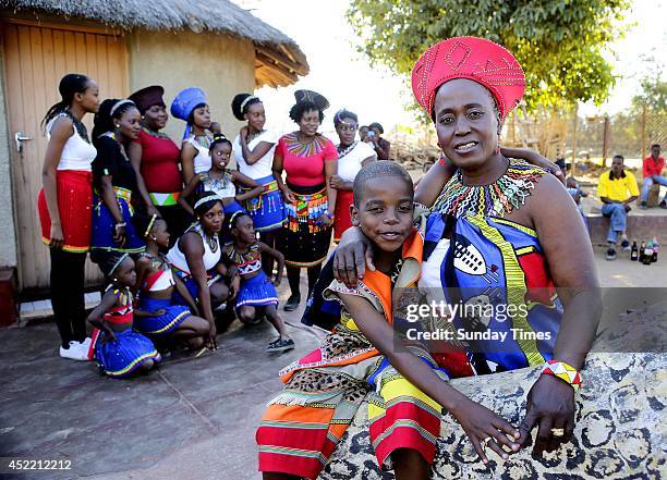 Anele Masilela, a nine year-old watches as his wife Helen Shabangu, 62 year-old kisses her 'real life' husband Abel, at their white wedding on July...