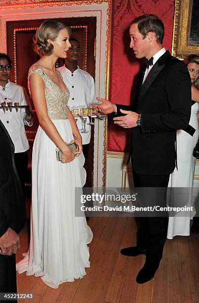 Taylor Swift and Prince William, Duke of Cambridge, attend the Winter Whites Gala in aid of Centrepoint at Kensington Palace on November 26, 2013 in...