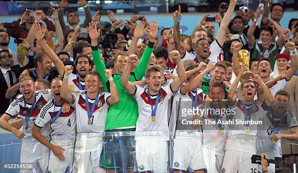 Philipp Lahm of Germany lifts the World Cup trophy during the award ceremony after the 2014 FIFA World Cup Brazil Final match between Germany and...