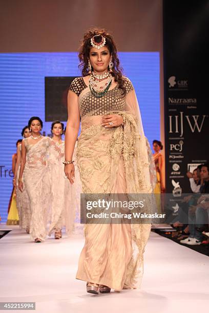 Raveena Tandon walks the runway at the Dipti & Amisha show during day 2 of the India International Jewellery Week 2014 at grand Hyatt on July 15,...