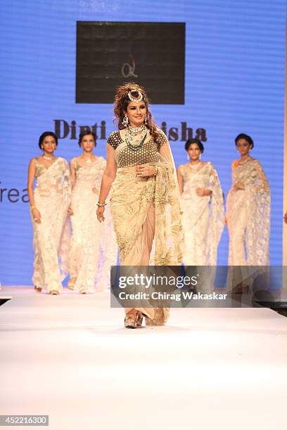 Raveena Tandon walks the runway at the Dipti & Amisha show during day 2 of the India International Jewellery Week 2014 at grand Hyatt on July 15,...