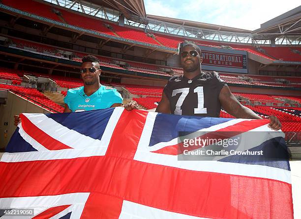Cameron Wake of Miami Dolphins poses for a photo with Menelik Watson of Oakland Raiders during a NFL Media Day at Wembley Stadium, on July 16, 2014...