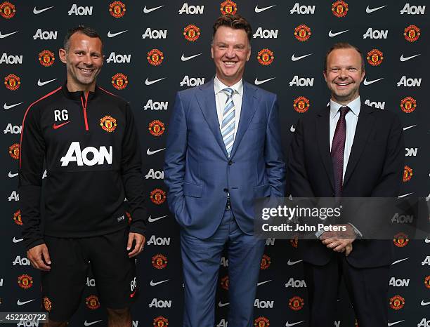 New manager Louis van Gaal of Manchester United poses with assistant manager Ryan Giggs and Executive Vice Chairman Ed Woodward as he starts his new...