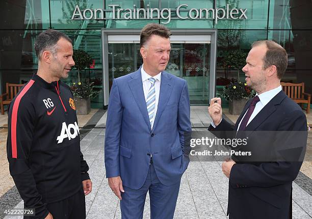 New manager Louis van Gaal of Manchester United poses with assistant manager Ryan Giggs and Executive Vice Chairman Ed Woodward as he starts his new...