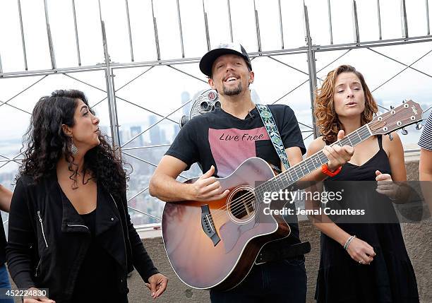 Musician Jason Mraz and Mona Tavakoli and Mai Bloomfield of the band Raining Jane perform after Jason Mraz announces his "Five Boroughs Tour" during...