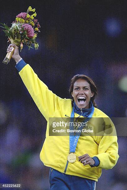 Australia's Cathy Freeman greets the cheering crowd from the gold medal stand after she won the women's 400-meter sprint.