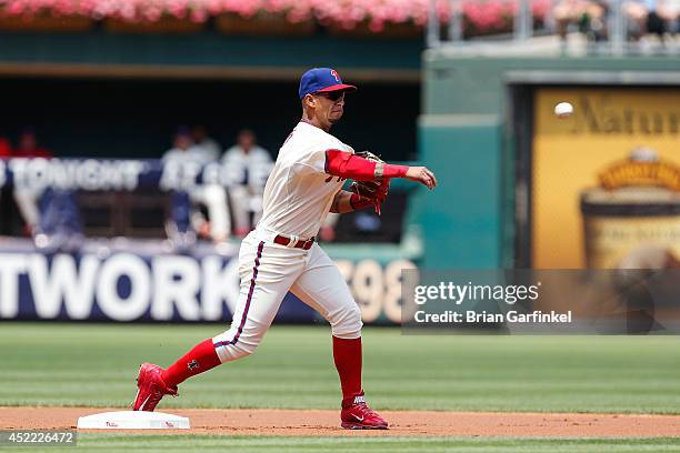 Ronny Cedeno of the Philadelphia Phillies turns a double play during the first game of a doubleheader against the Atlanta Braves at Citizens Bank...