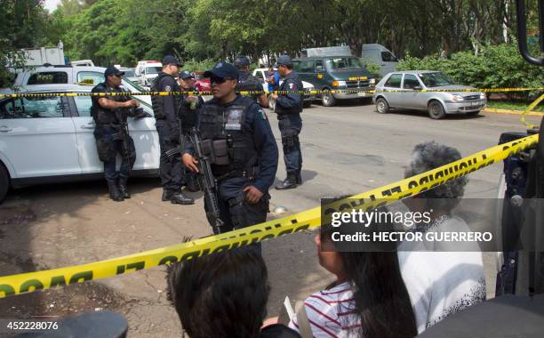 Relatives of children await outside the shelter "La Gran Familia" where a police raid on the eve rescued 596 people, including 458 children in...