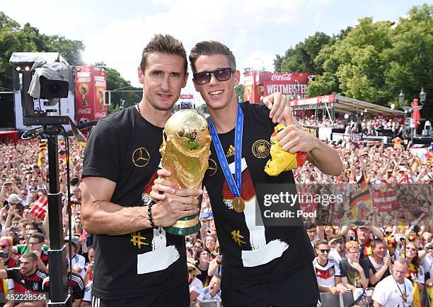 Miroslav Klose and Erik Durm celebrate during the German team victory ceremony on July 15, 2014 in Berlin, Germany. Germany won the 2014 FIFA World...