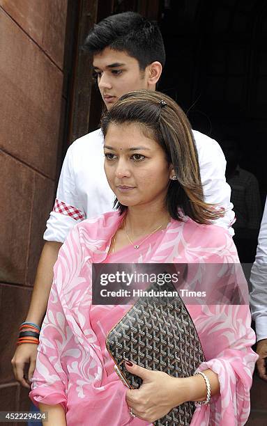 Wife of Congress MP Jyotiraditya Scindia, Priyadarshini Raje Scindia with her son Aryaman Scindia come out after visiting Parliament house on July...