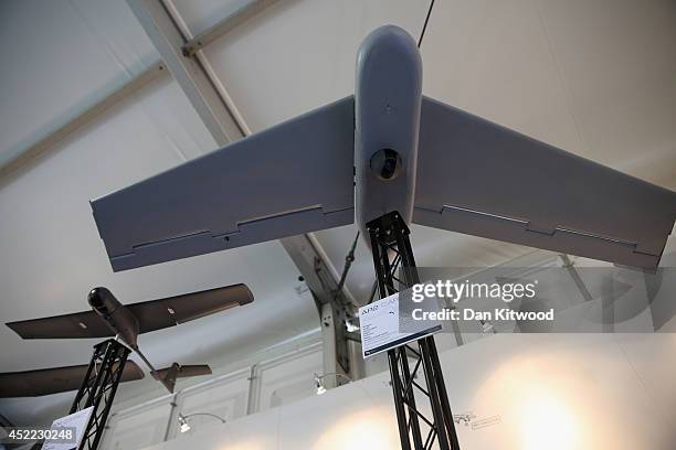 Drones are displayed on the Tekever stand on day four of the Farnborough International Airshow on July 16, 2014 in Farnborough, England. The...